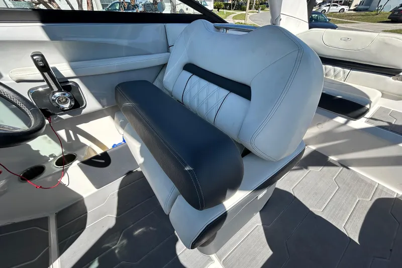 Slide: The Image of Interior of a 2022 Regal LS2 boat featuring modern seating and steering controls. - 81