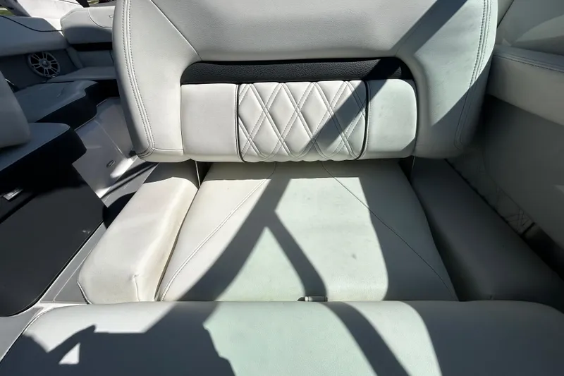 Slide: The Image of 2022 Regal LS2 boat interior with white leather seating and diamond stitching. - 83