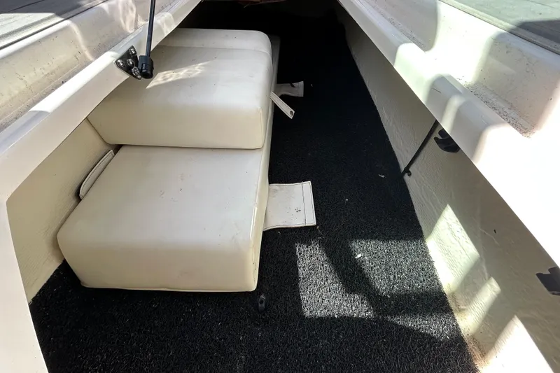 Slide: The Image of Interior view of 2022 Regal LS2 boat with cushioned seating and carpeted flooring. - 93