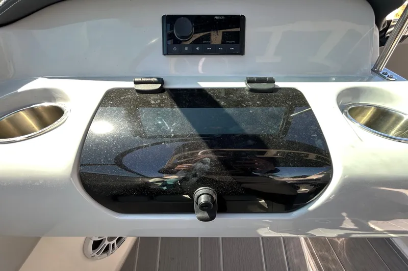Slide: The Image of 2022 Regal LS2 boat dashboard with audio controls and cup holders. - 94