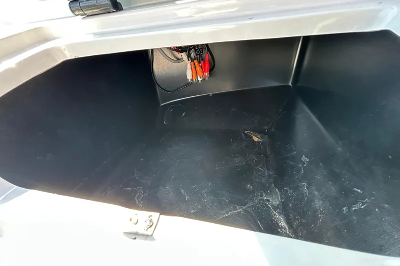 Slide: The Image of Storage compartment of 2022 Regal LS2 boat, featuring wiring and spacious interior. - 96