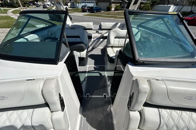 Slide: The Image of 2022 Regal LS2 boat interior with white leather seats and glass windshields. - 97