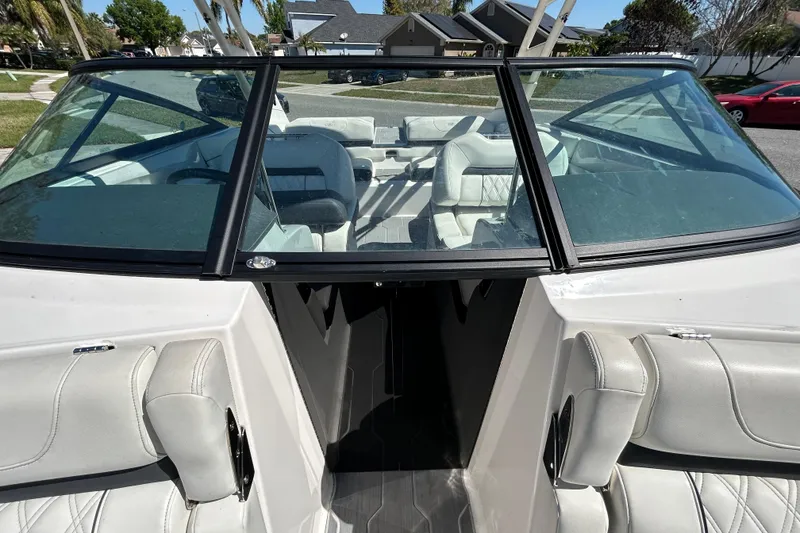 Slide: The Image of 2022 Regal LS2 boat interior with white leather seats and windshield view. - 98