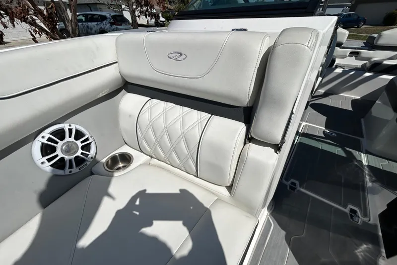 Slide: The Image of Luxurious interior of 2022 Regal LS2 boat with white seating and speaker system. - 99