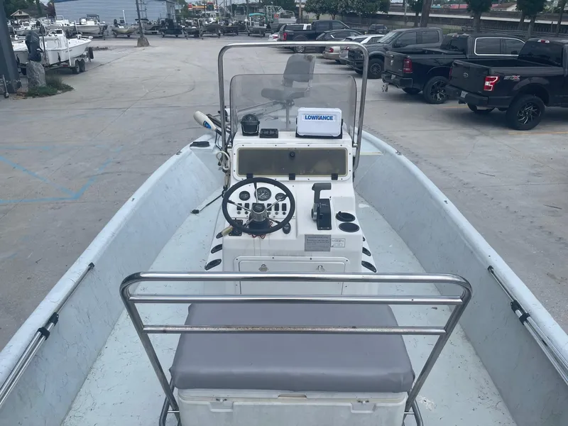 Slide: The Image of 2002 Champion 230-RV boat interior with steering console and seating. - 10