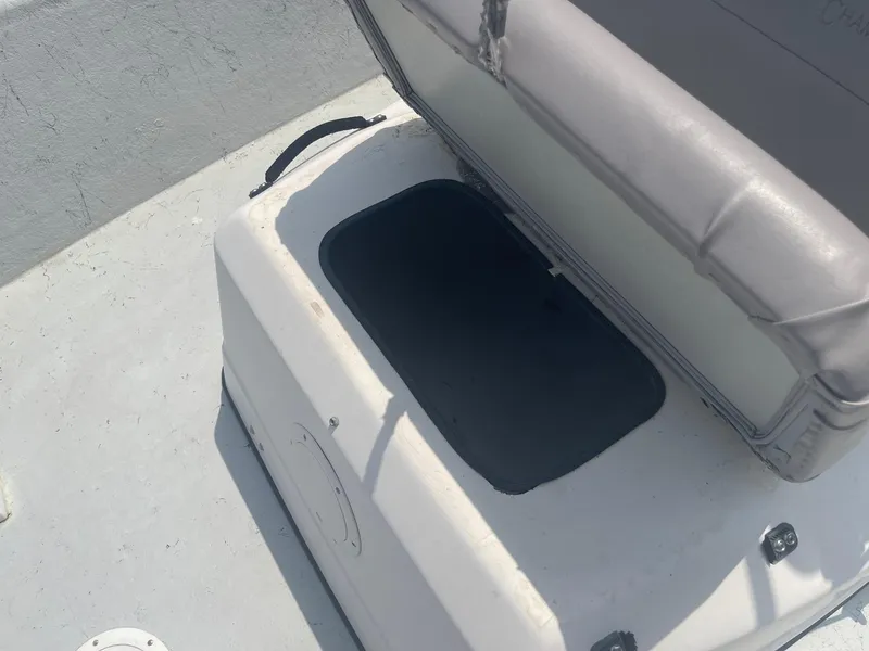 Slide: The Image of Open storage compartment on a 2002 Champion 230-RV boat. - 13
