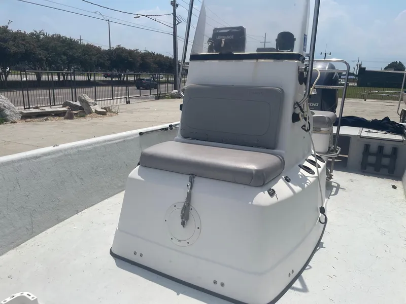 Slide: The Image of 2002 Champion 230-RV boat with center console and cushioned seating. - 14