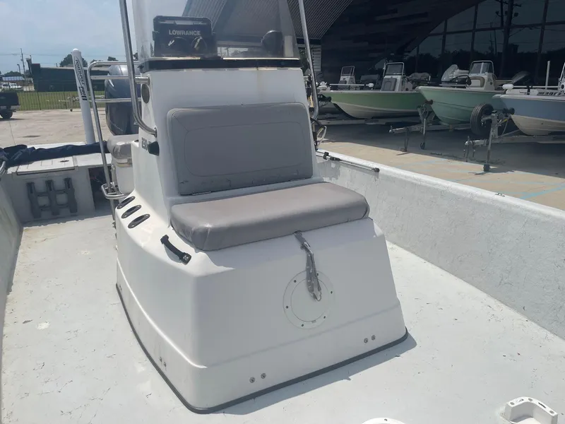 Slide: The Image of 2002 Champion 230-RV boat interior with seating and console. - 15