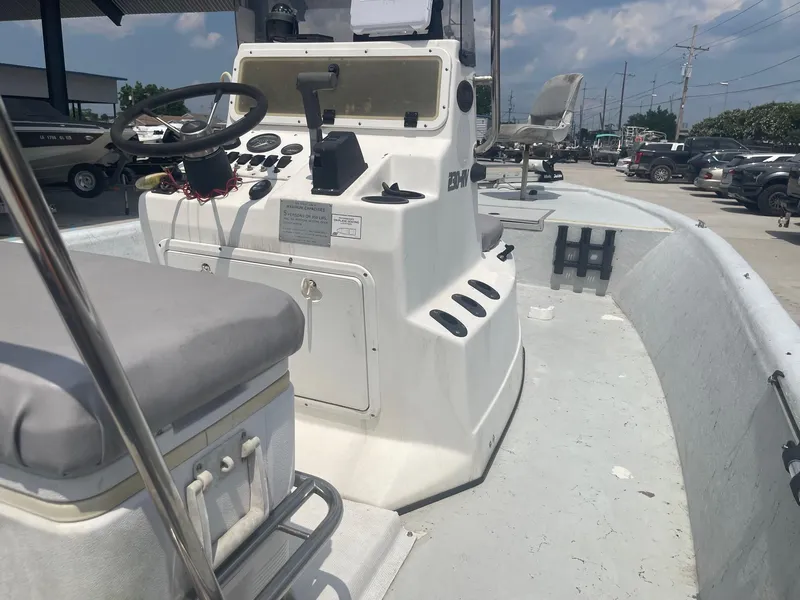 Slide: The Image of 2002 Champion 230-RV boat interior with steering console and seating. - 16