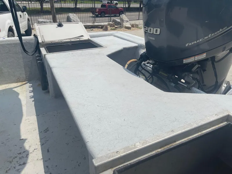 Slide: The Image of 2002 Champion 230-RV boat with a powerful outboard motor. - 18