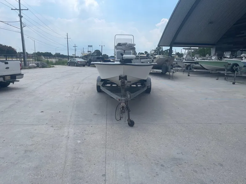 Slide: The Image of 2002 Champion 230-RV boat on trailer in outdoor storage area. - 2