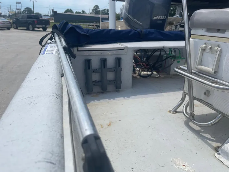 Slide: The Image of 2002 Champion 230-RV boat interior with motor and seating. - 20