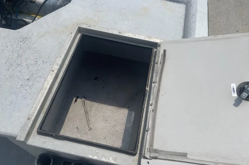 Slide: The Image of Open storage compartment on a 2002 Champion 230-RV boat. - 22