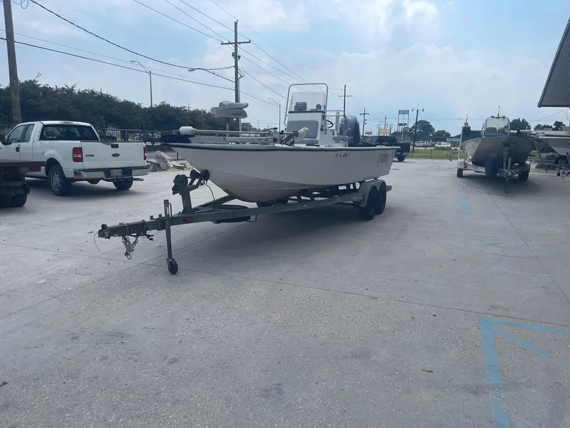 Slide: The Image of 2002 Champion 230-RV boat on trailer in parking lot. - 3