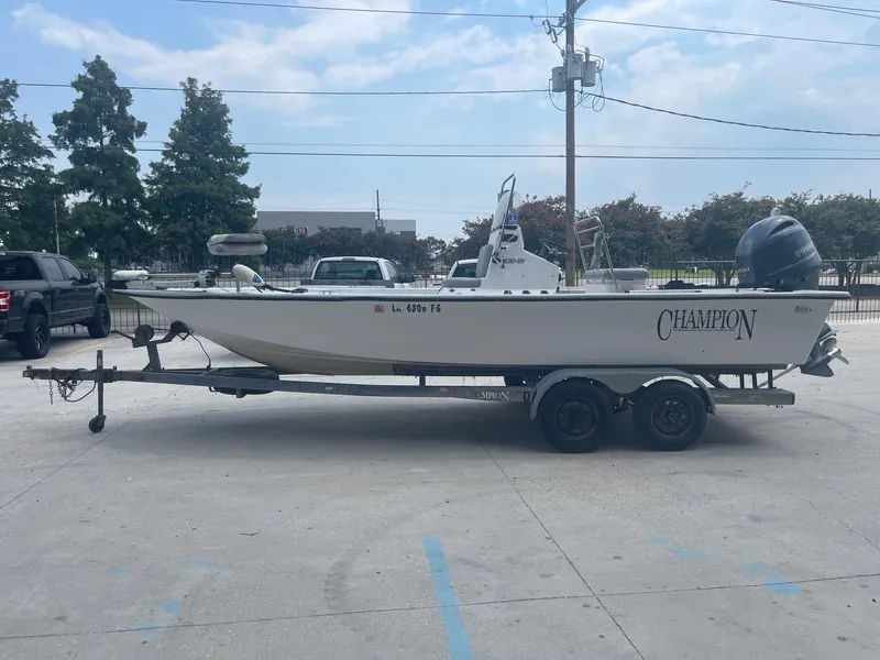 Slide: The Image of 2002 Champion 230-RV boat on trailer in parking lot. - 4