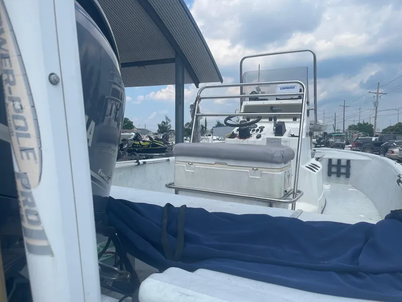 Slide: The Image of 2002 Champion 230-RV boat with Yamaha outboard motor, docked under a canopy. - 7