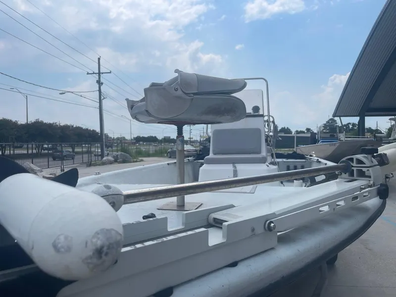 Slide: The Image of 2002 Champion 230-RV boat docked under a partly cloudy sky. - 8