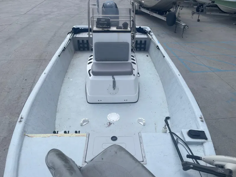 Slide: The Image of 2002 Champion 230-RV boat interior with center console and seating. - 9