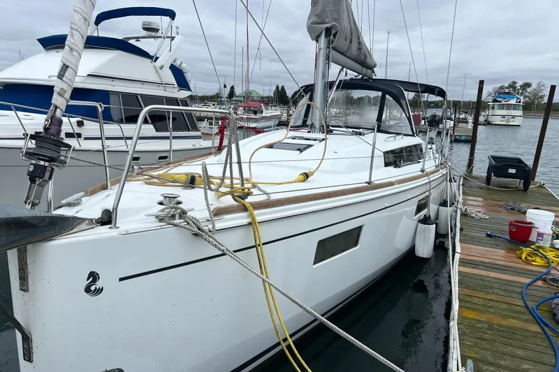 The Image of 2017 Beneteau Oceanis 38.1 sailboat docked at marina, overcast sky. - 0
