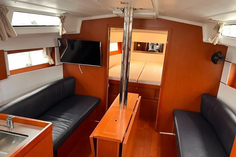 Slide: The Image of Interior of 2017 Beneteau Oceanis 38.1 yacht with modern seating and TV. - 16