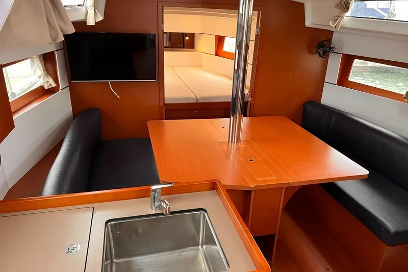 Slide: The Image of Interior of 2017 Beneteau Oceanis 38.1 yacht with dining area and kitchenette. - 17