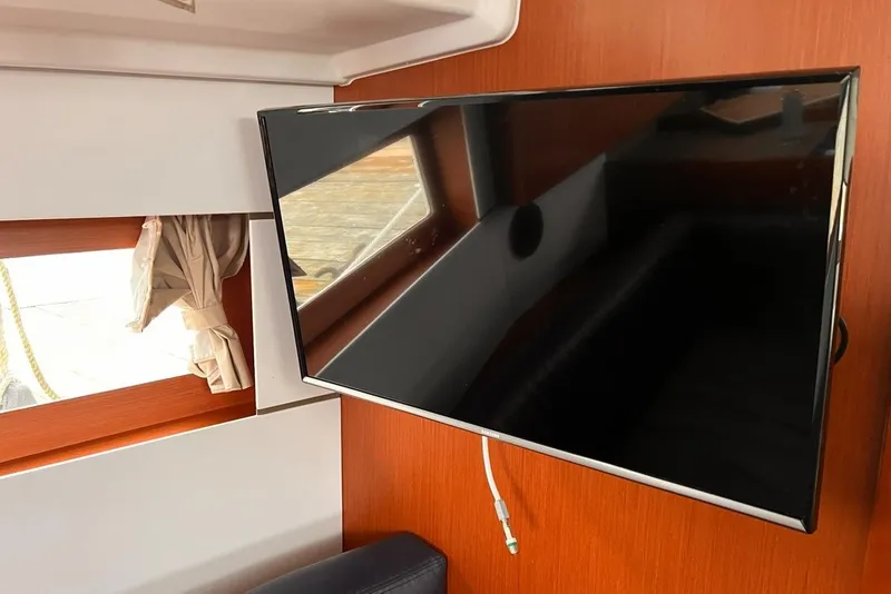 Slide: The Image of Interior of 2017 Beneteau Oceanis 38.1 yacht with mounted flat-screen TV. - 18