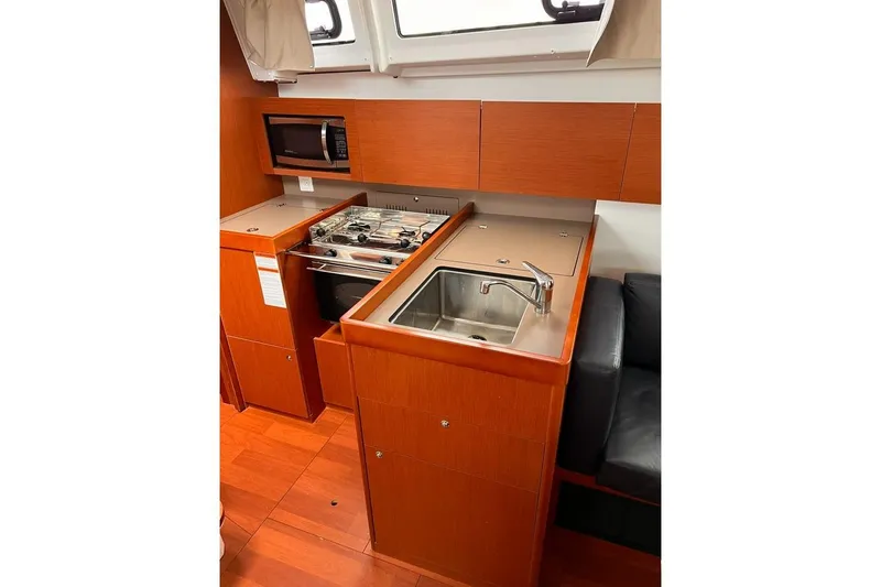Slide: The Image of 2017 Beneteau Oceanis 38.1 yacht kitchen with stove, sink, and microwave. - 19