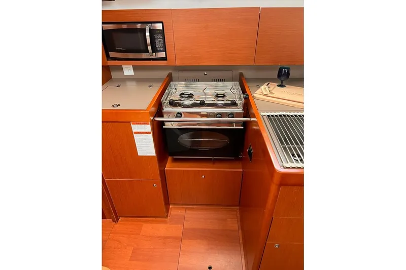 Slide: The Image of Galley kitchen in 2017 Beneteau Oceanis 38.1 yacht with stove and microwave. - 20