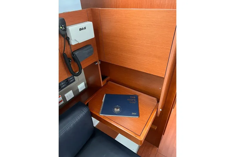 Slide: The Image of Navigation station on 2017 Beneteau Oceanis 38.1 with ship's log and communication equipment. - 22