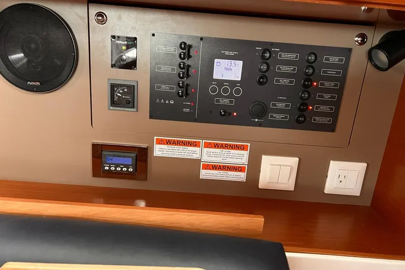 Slide: The Image of Control panel of 2017 Beneteau Oceanis 38.1 yacht with warning labels and switches. - 24