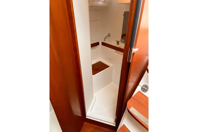 Slide: The Image of 2017 Beneteau Oceanis 38.1 yacht interior bathroom with wooden accents and modern fixtures. - 31