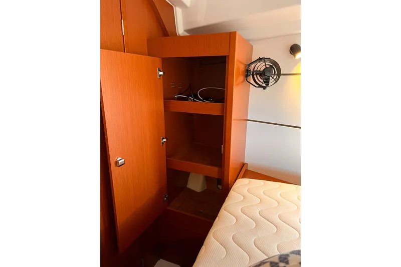Slide: The Image of 2017 Beneteau Oceanis 38.1 sailboat cockpit with wooden table, docked at marina. - 7