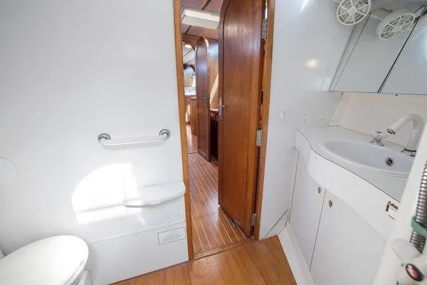Slide: The Image of Bathroom interior of 1989 Wauquiez Centurion 47 yacht, featuring sink and wooden accents. - 13