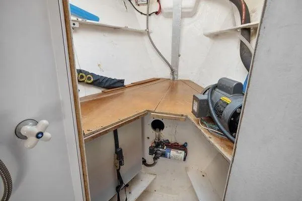 Slide: The Image of Interior of 1989 Wauquiez Centurion 47 sailboat, featuring storage and equipment space. - 16