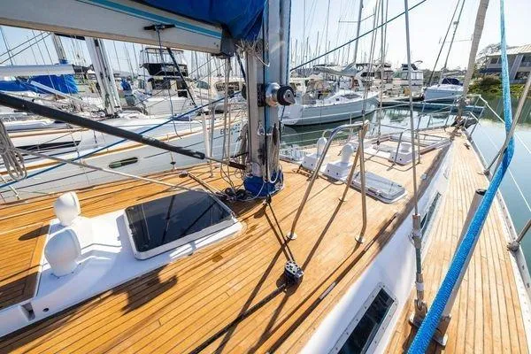 Slide: The Image of 1989 Wauquiez Centurion 47 sailboat with teak deck in marina setting. - 5