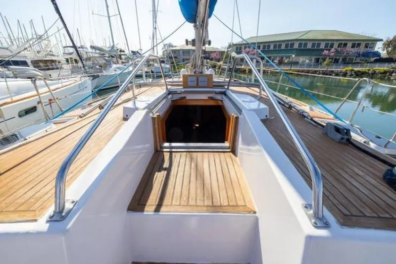 Slide: The Image of 1989 Wauquiez Centurion 47 sailboat deck with open cabin, docked in marina. - 7