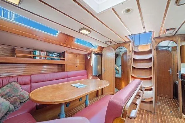 Slide: The Image of Interior of 1989 Wauquiez Centurion 47 yacht with wooden finish and red seating. - 8