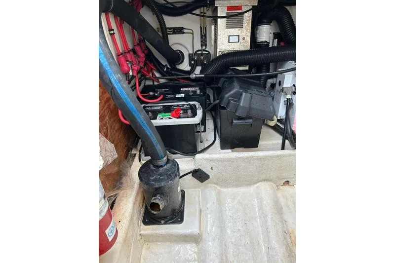 Slide: The Image of 1995 Formula 31 Performance Cruiser engine compartment with batteries and wiring. - 11