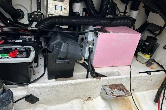 Slide: The Image of Engine compartment of a 1995 Formula 31 Performance Cruiser with batteries and wiring. - 12