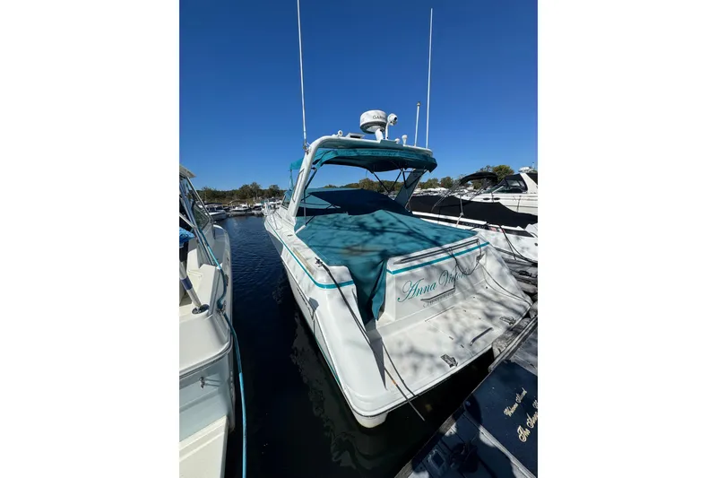 Slide: The Image of 1995 Formula 31 Performance Cruiser docked at marina under clear blue sky. - 2
