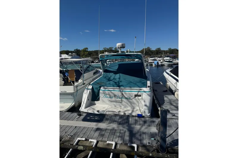 Slide: The Image of 1995 Formula 31 Performance Cruiser docked at marina under clear blue sky. - 4