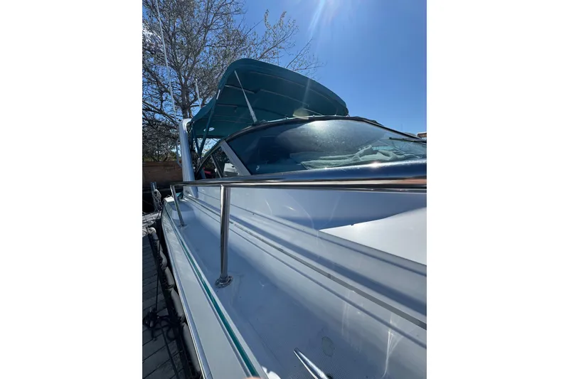 Slide: The Image of 1995 Formula 31 Performance Cruiser with blue canopy under clear sky. - 5