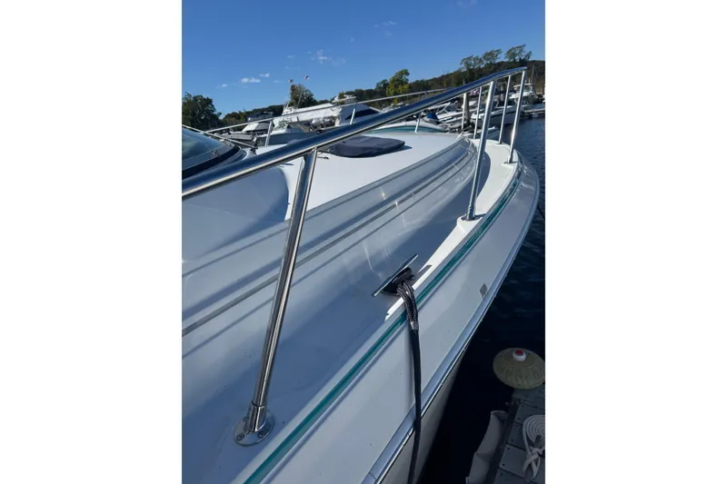 Slide: The Image of 1995 Formula 31 Performance Cruiser boat docked, showcasing sleek design and stainless steel railings. - 6