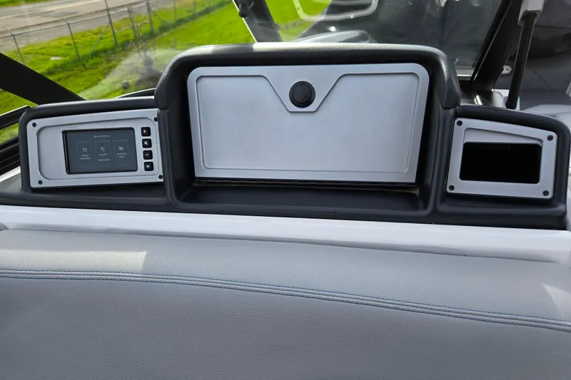 Slide: The Image of 2023 Supra SL 450 dashboard with digital display and storage compartments. - 16