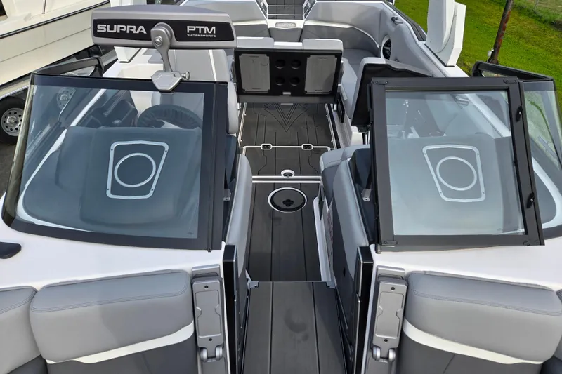 Slide: The Image of 2023 Supra SL 450 boat interior with sleek seating and modern design. - 24