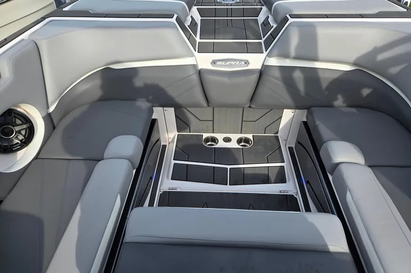 Slide: The Image of 2023 Supra SL 450 boat interior with gray seating and cup holders. - 25