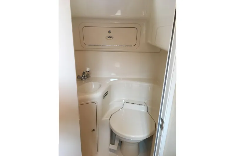 Slide: The Image of 2002 Sea Ray 410 Sundancer bathroom with compact sink and toilet. - 11