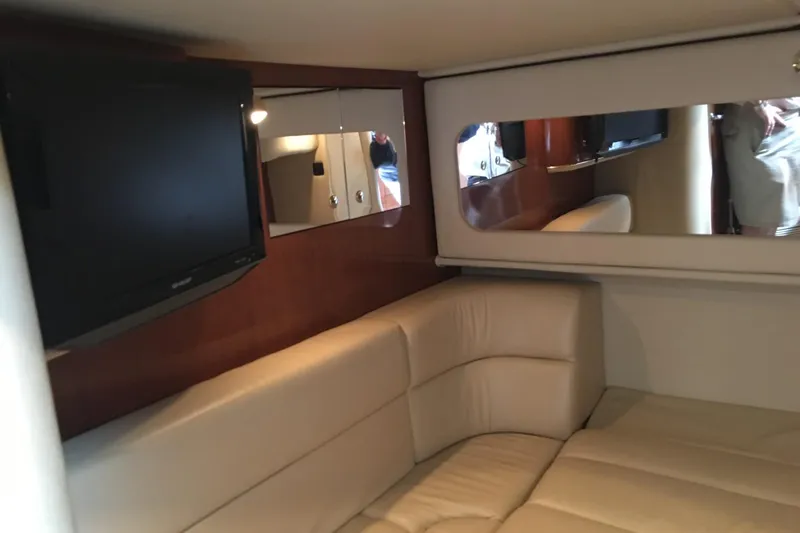 Slide: The Image of Interior of 2002 Sea Ray 410 Sundancer yacht with beige seating and wall-mounted TV. - 8