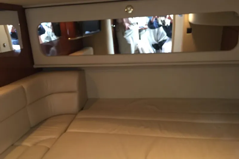 Slide: The Image of Interior of 2002 Sea Ray 410 Sundancer yacht with beige seating and mirror. - 9
