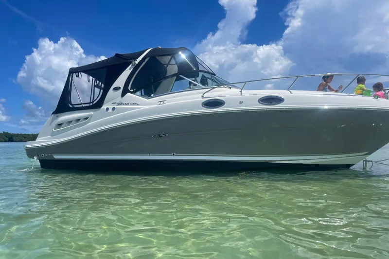 The Image of 2006 Sea Ray Sundancer 260 boat on clear water under blue sky. - 0